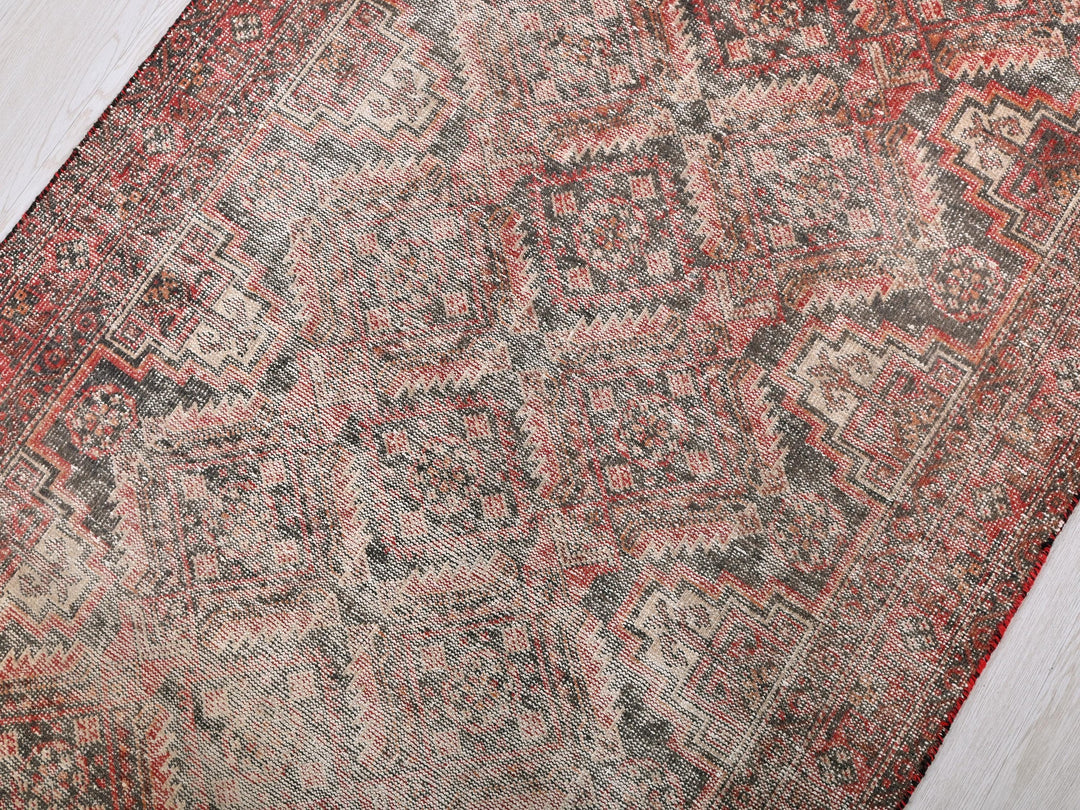 an old rug is laying on the floor