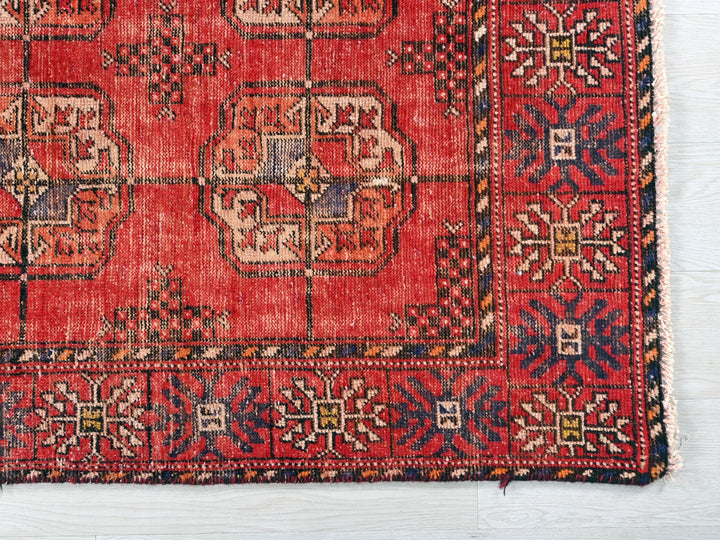 a red rug with a pattern on the middle of it