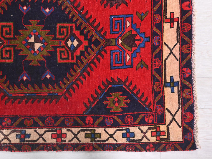 a red and blue rug with a design on it