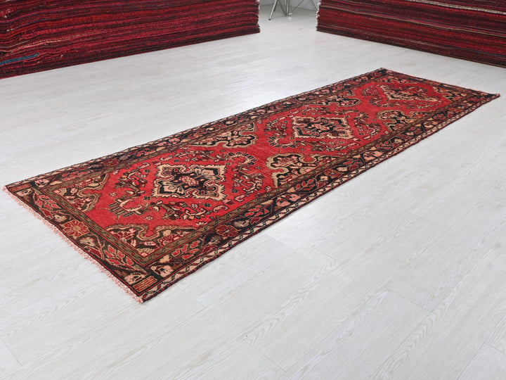 a red rug on the floor of a room