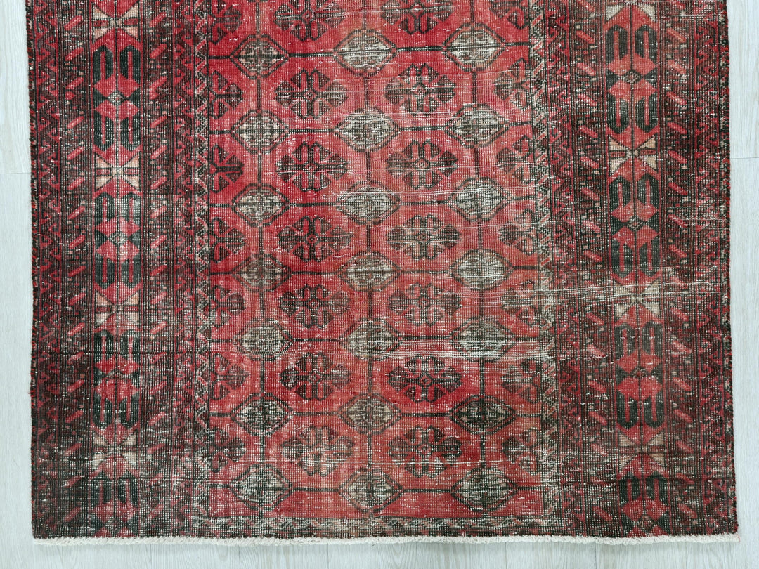 a red rug with a pattern on it