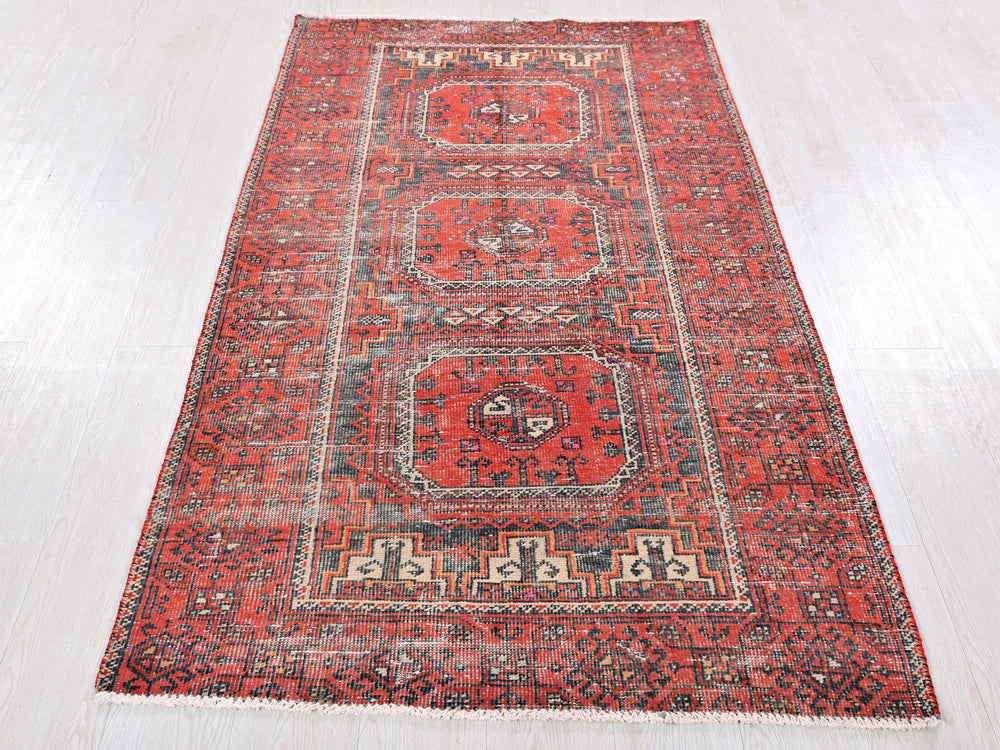 a large red rug on a white floor