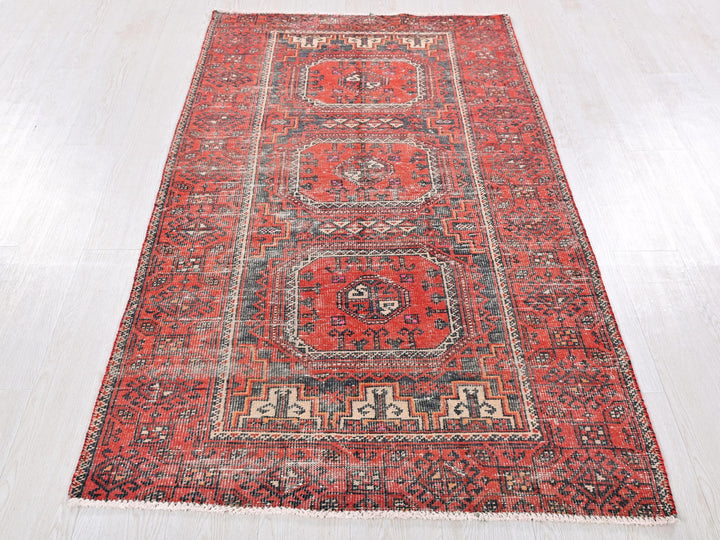 a large red rug on a white floor