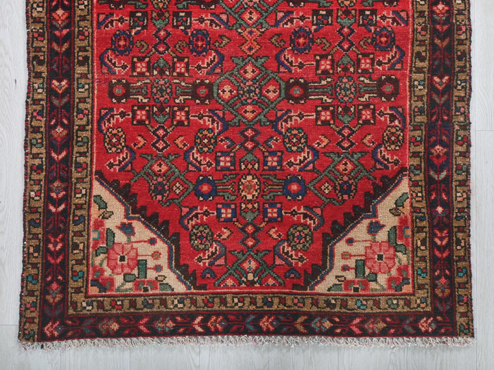 a red rug with an intricate design on it