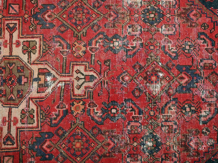 a red rug with many different designs on it
