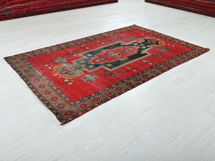 a red rug on the floor of a room