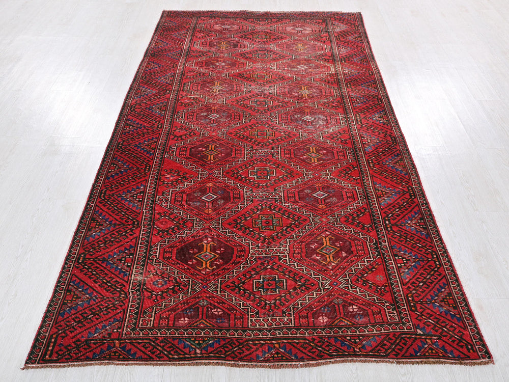a red rug on a white floor in a room