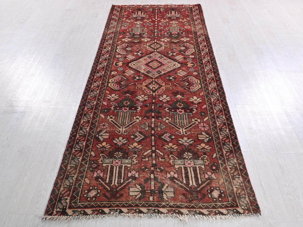 a large red rug on a white floor