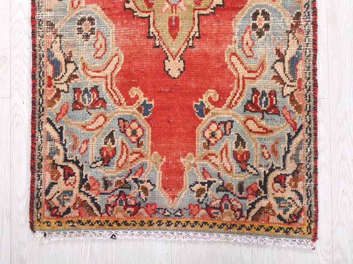 a red and blue rug on a white floor