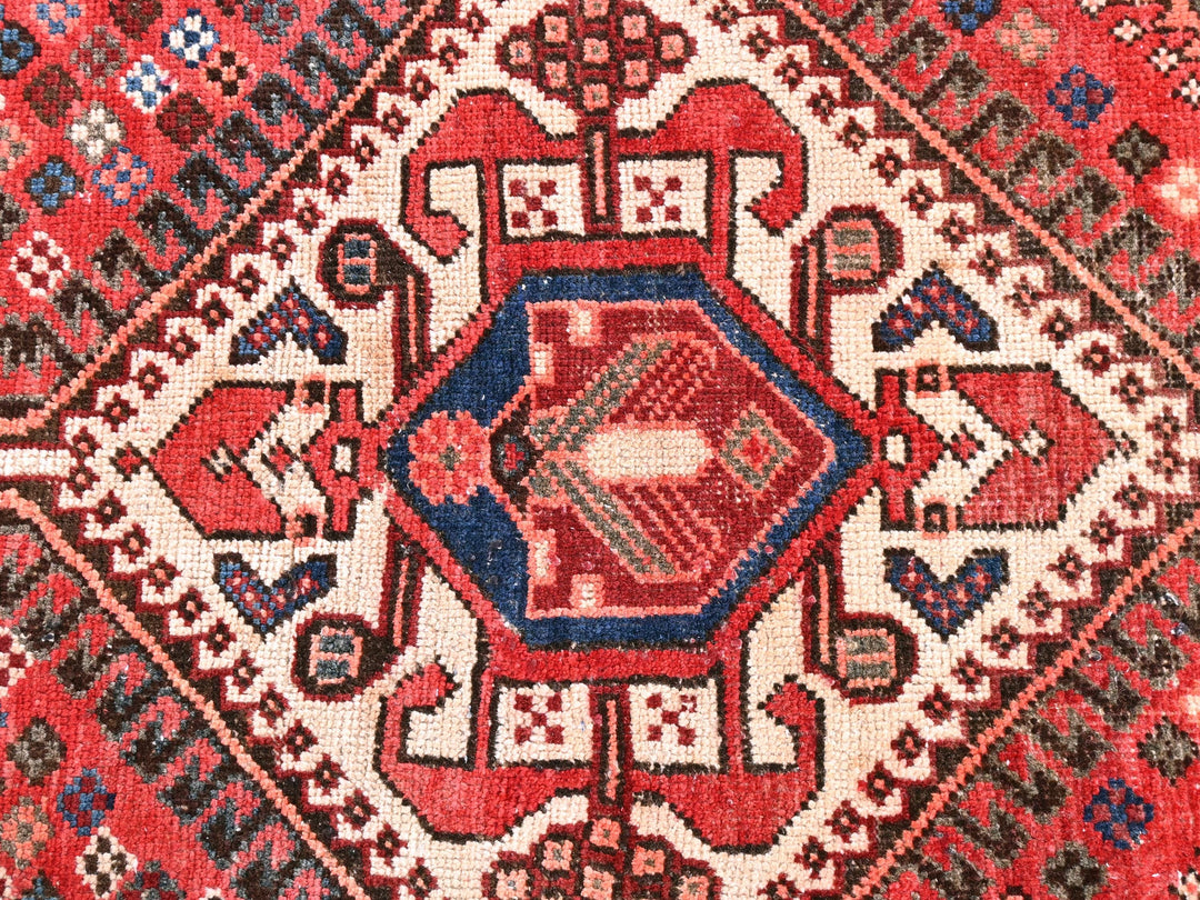 a close up of a rug with a red and blue design