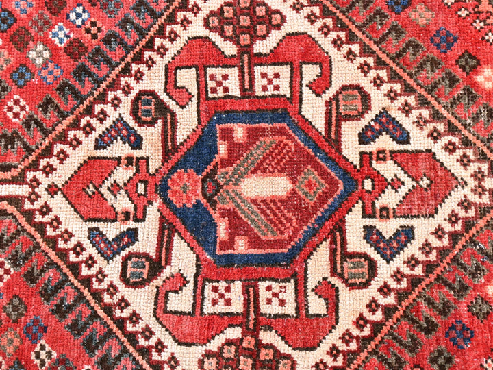 a close up of a rug with a red and blue design