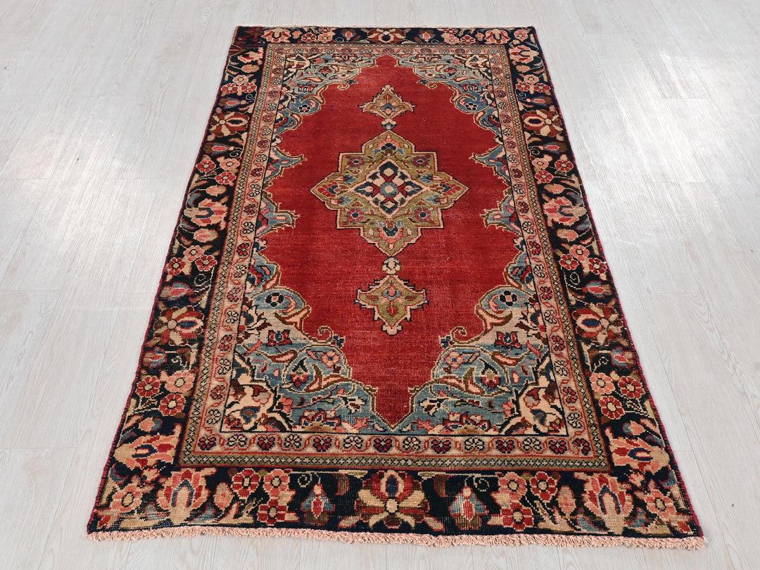 a red rug on a white wooden floor