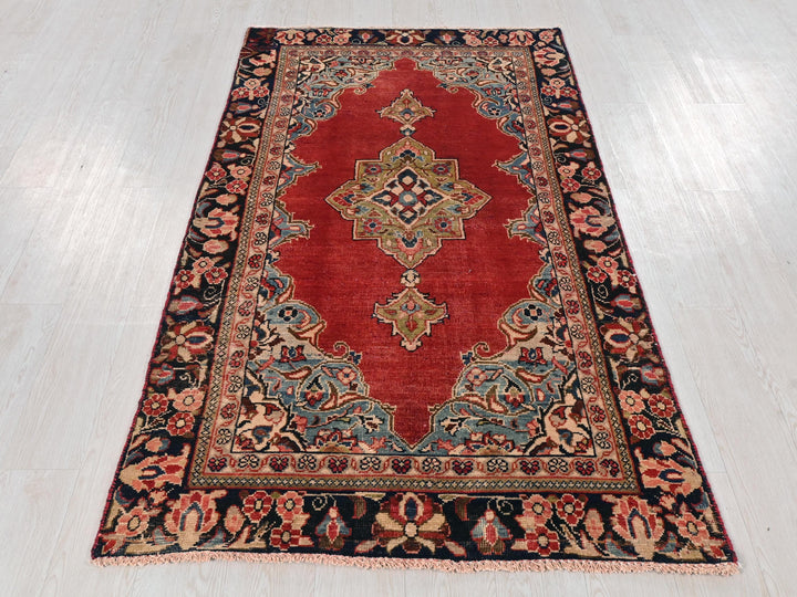 a red rug on a white wooden floor