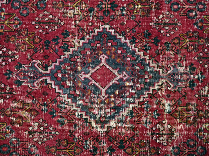 a red rug with an intricate design on it