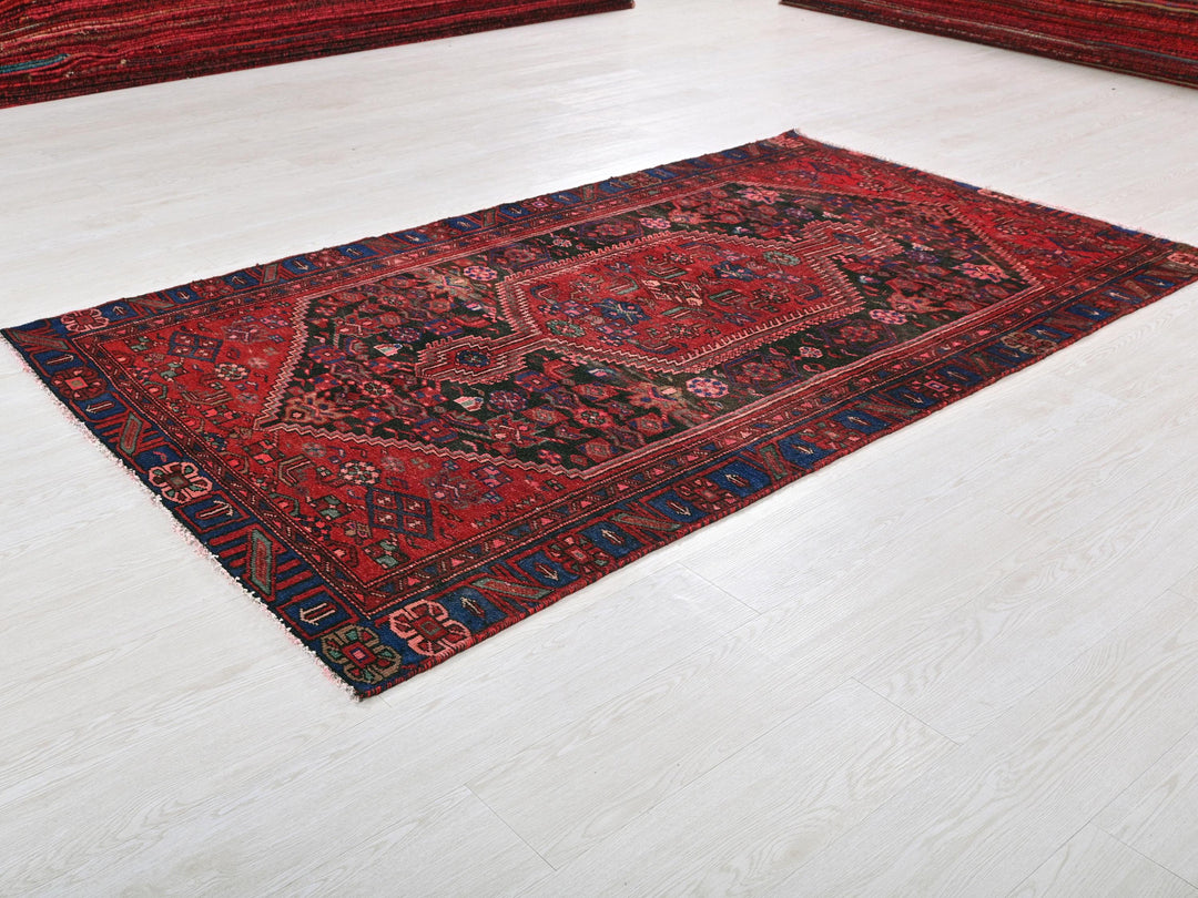 a red rug on the floor of a room