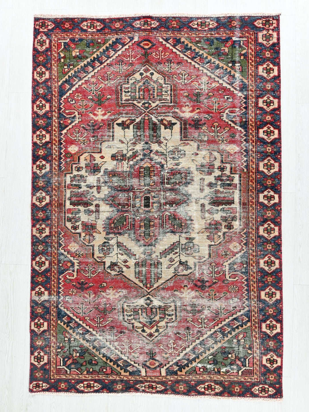 a red, blue, and green rug with an intricate design
