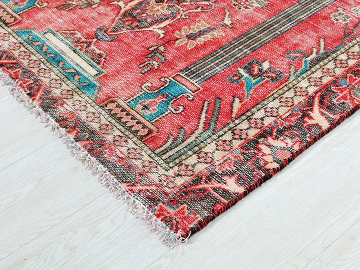 a red rug on a white wooden floor