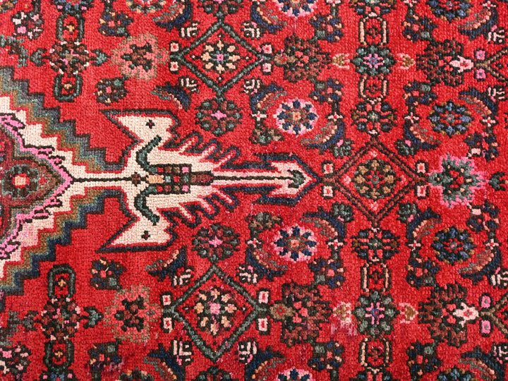 a red rug with a design on it