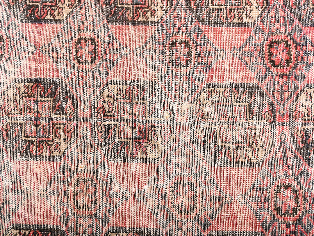 a red and black rug with a pattern on it