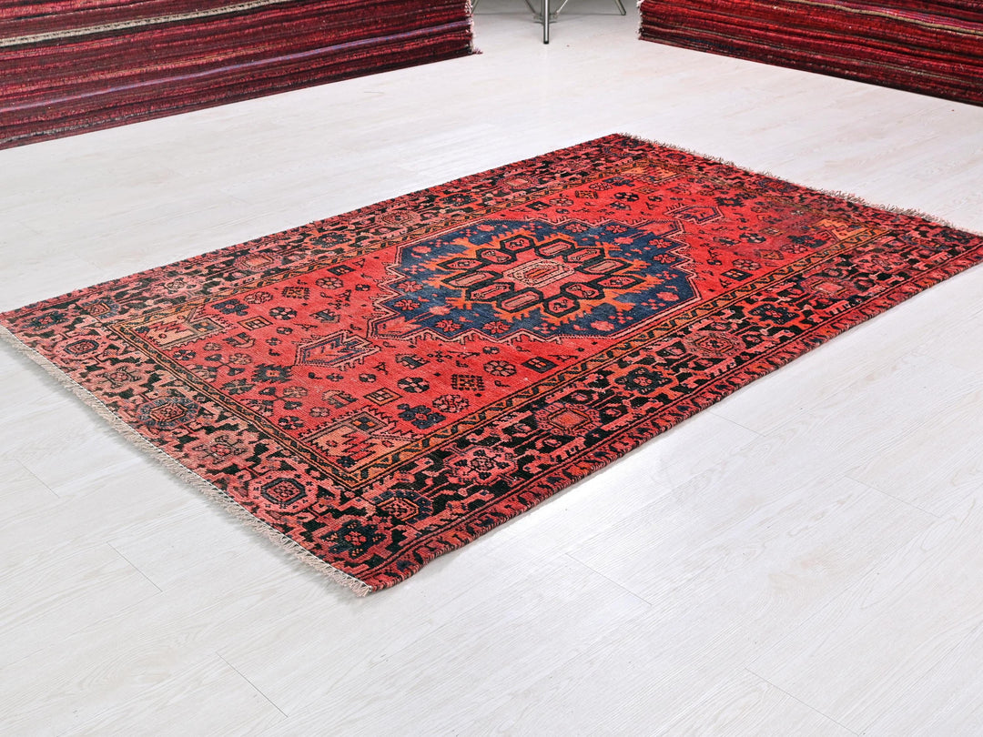 a red rug on the floor of a room