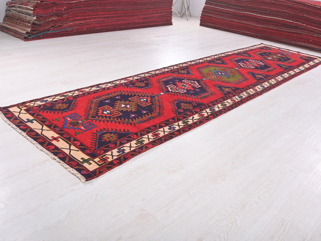 a pile of red rugs sitting on top of a white floor