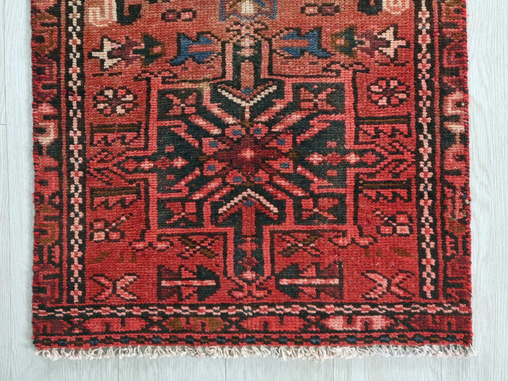 a red rug with an intricate design on it