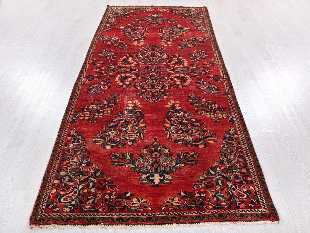 a long red rug on a white floor