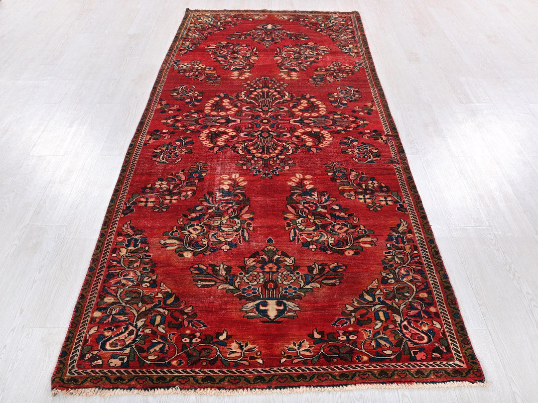 a long red rug on a white floor