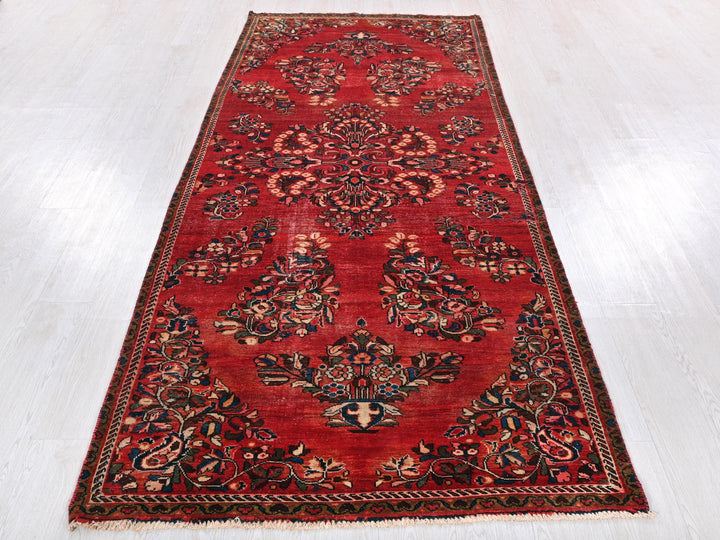 a long red rug on a white floor