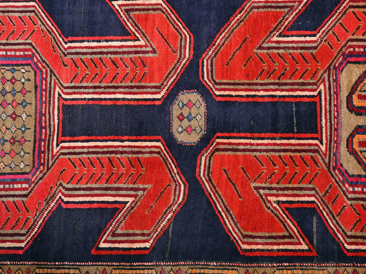 a red and blue rug with a design on it