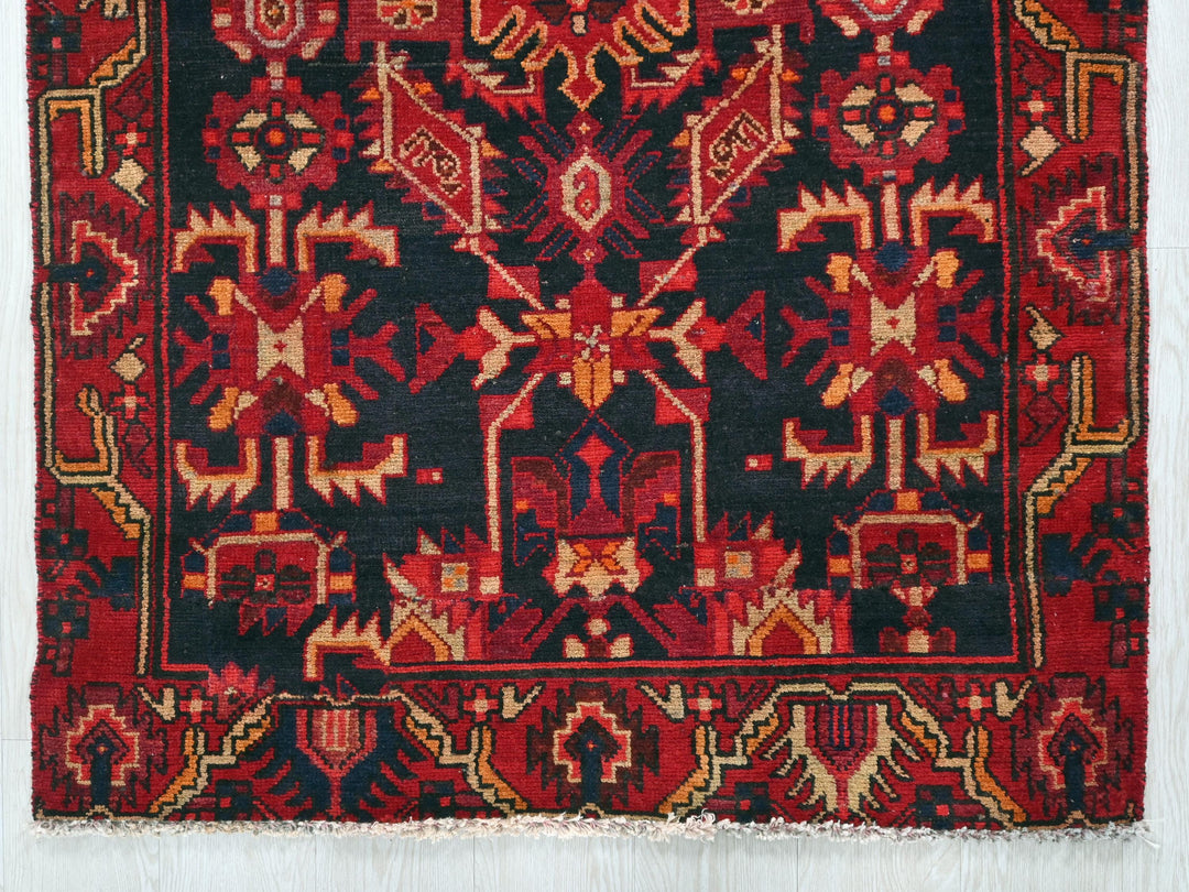 a red and black rug on a white background