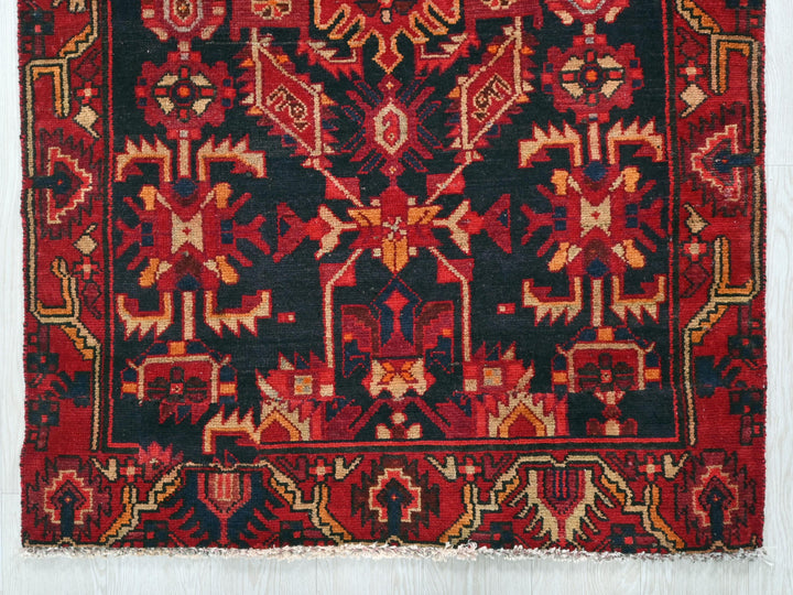a red and black rug on a white background