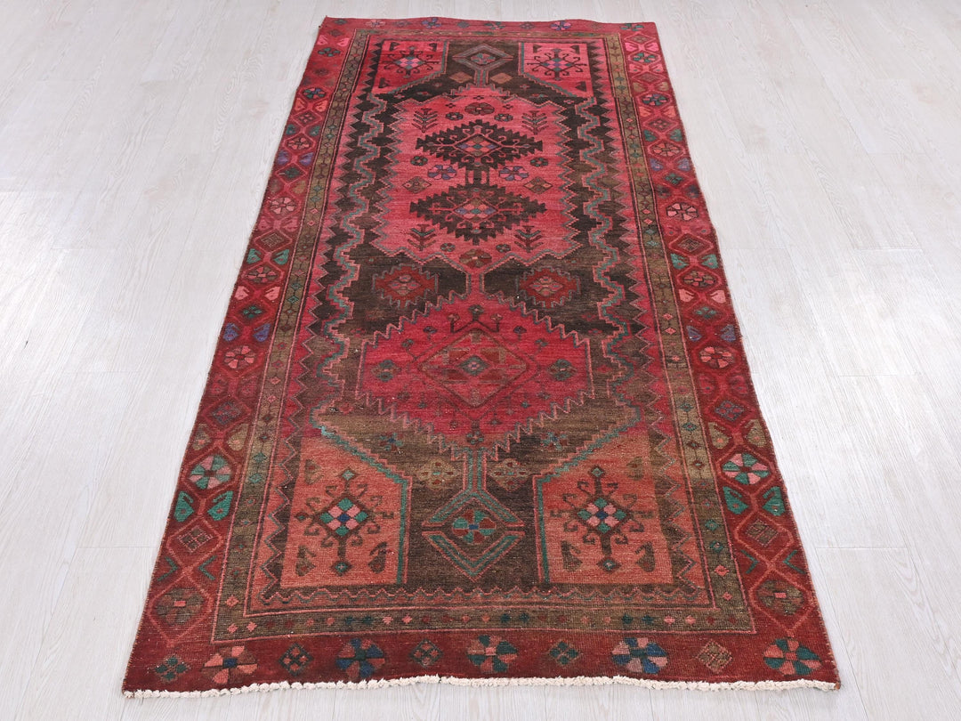 a red rug on a white floor in a room