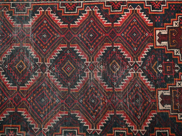 a red and black rug with a pattern on it