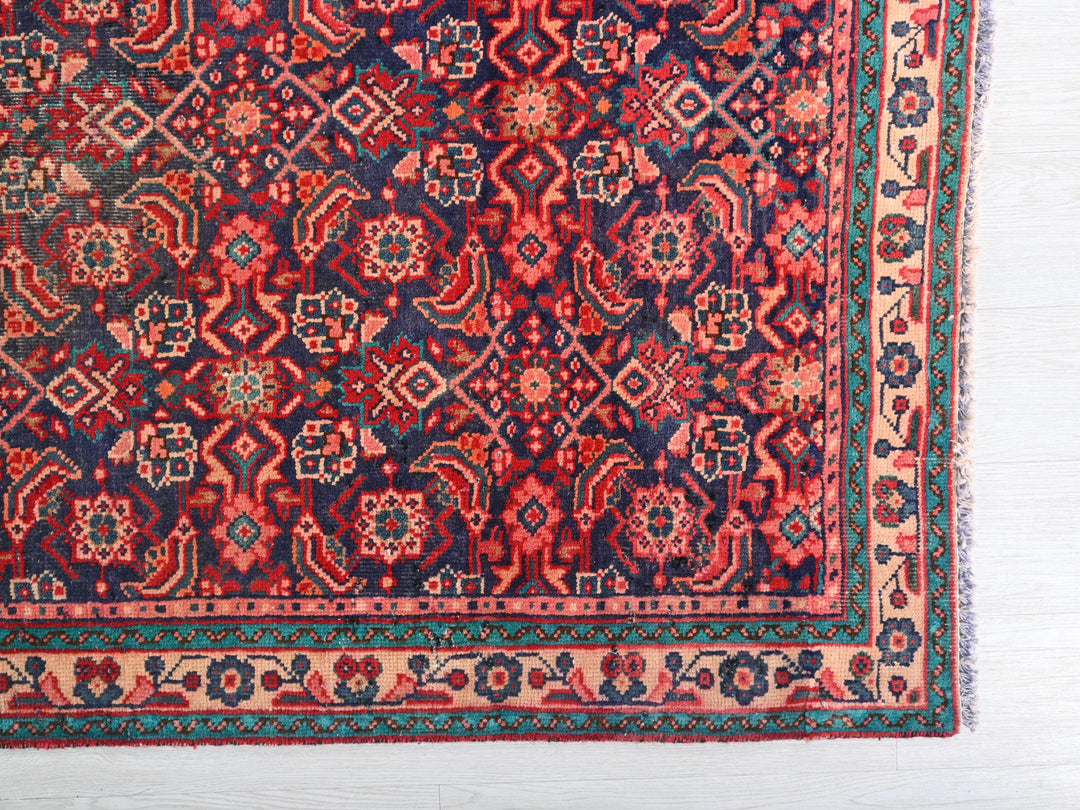a red and blue rug on a white floor