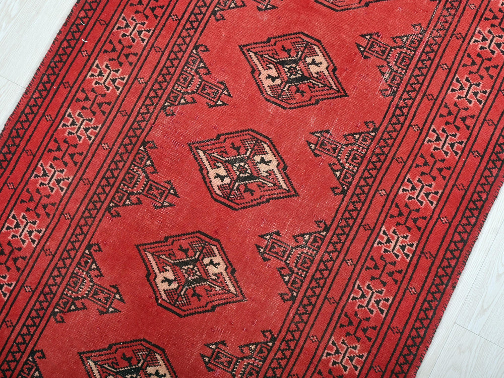 a red rug with a design on it