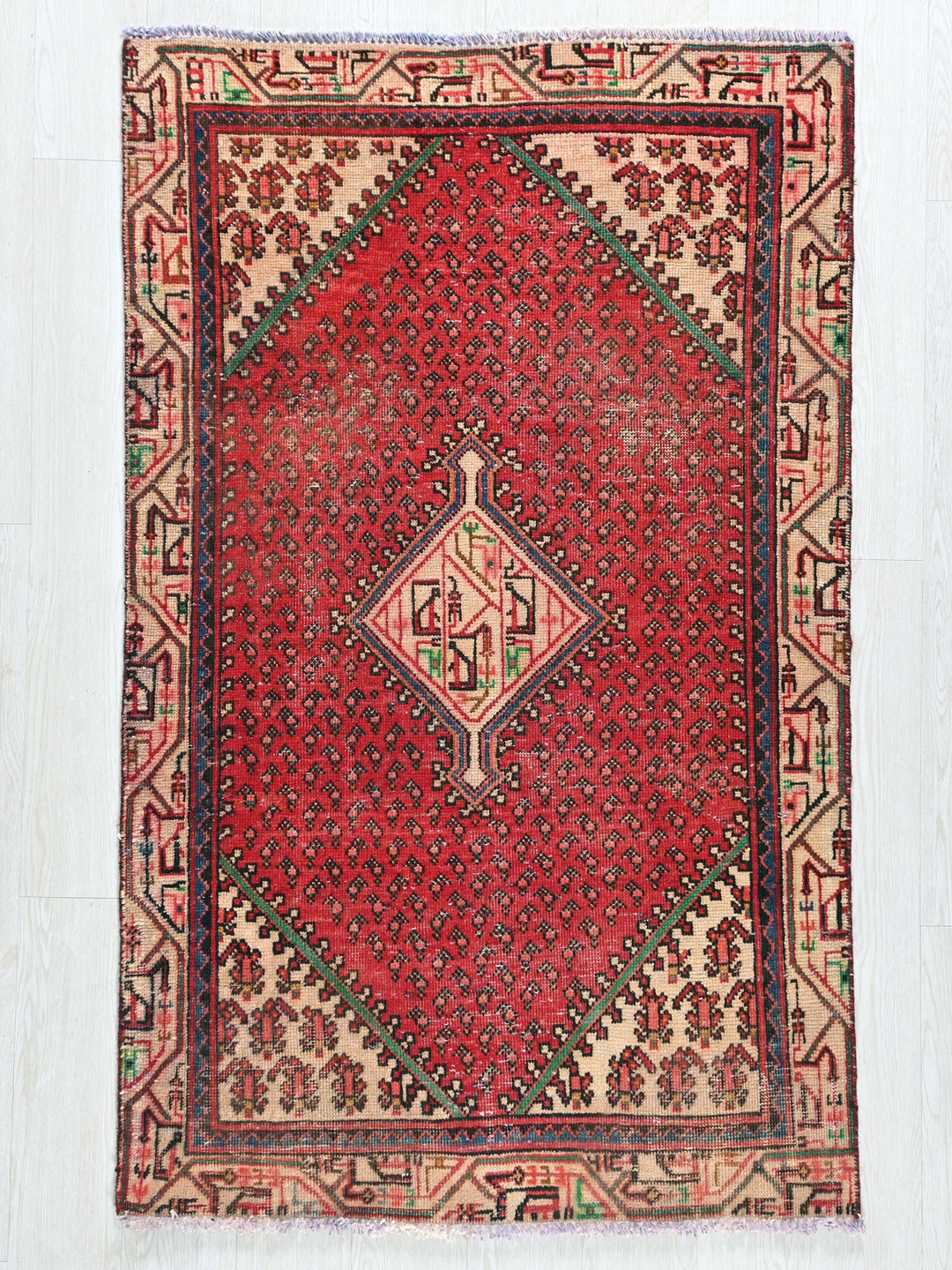 a red rug with a diamond design on it