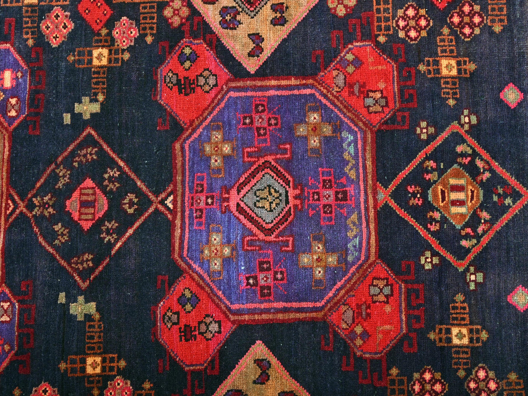 a blue rug with a colorful design on it