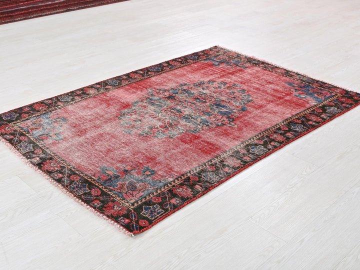 a red rug on the floor of a room