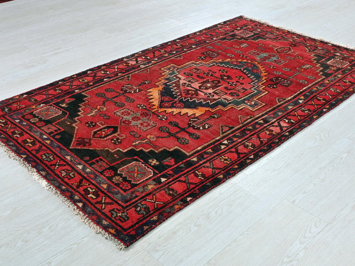 a red rug on the floor of a room