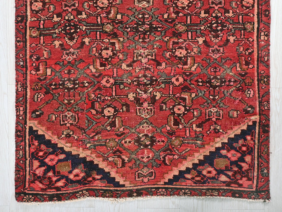 a red rug with a black border on a white background