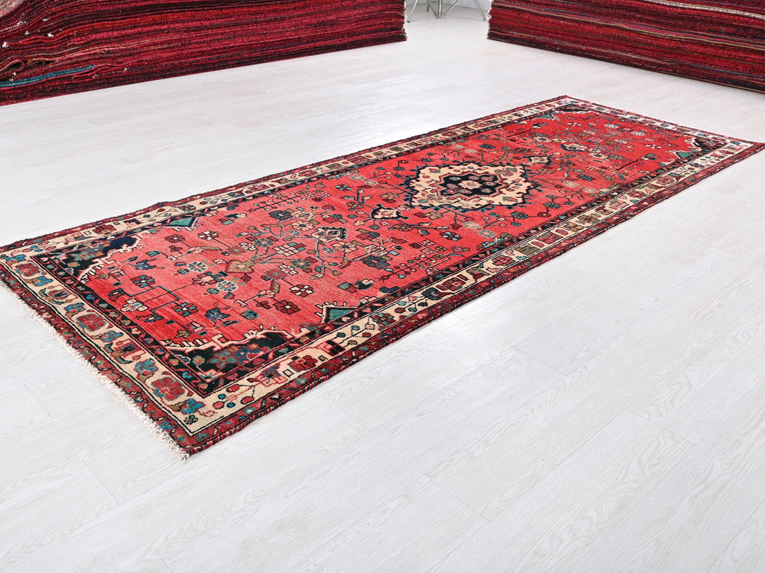 a red rug is laying on a white floor