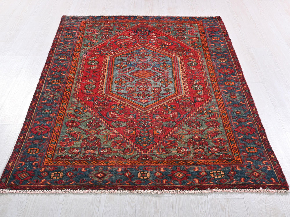 a red and blue rug on a white floor