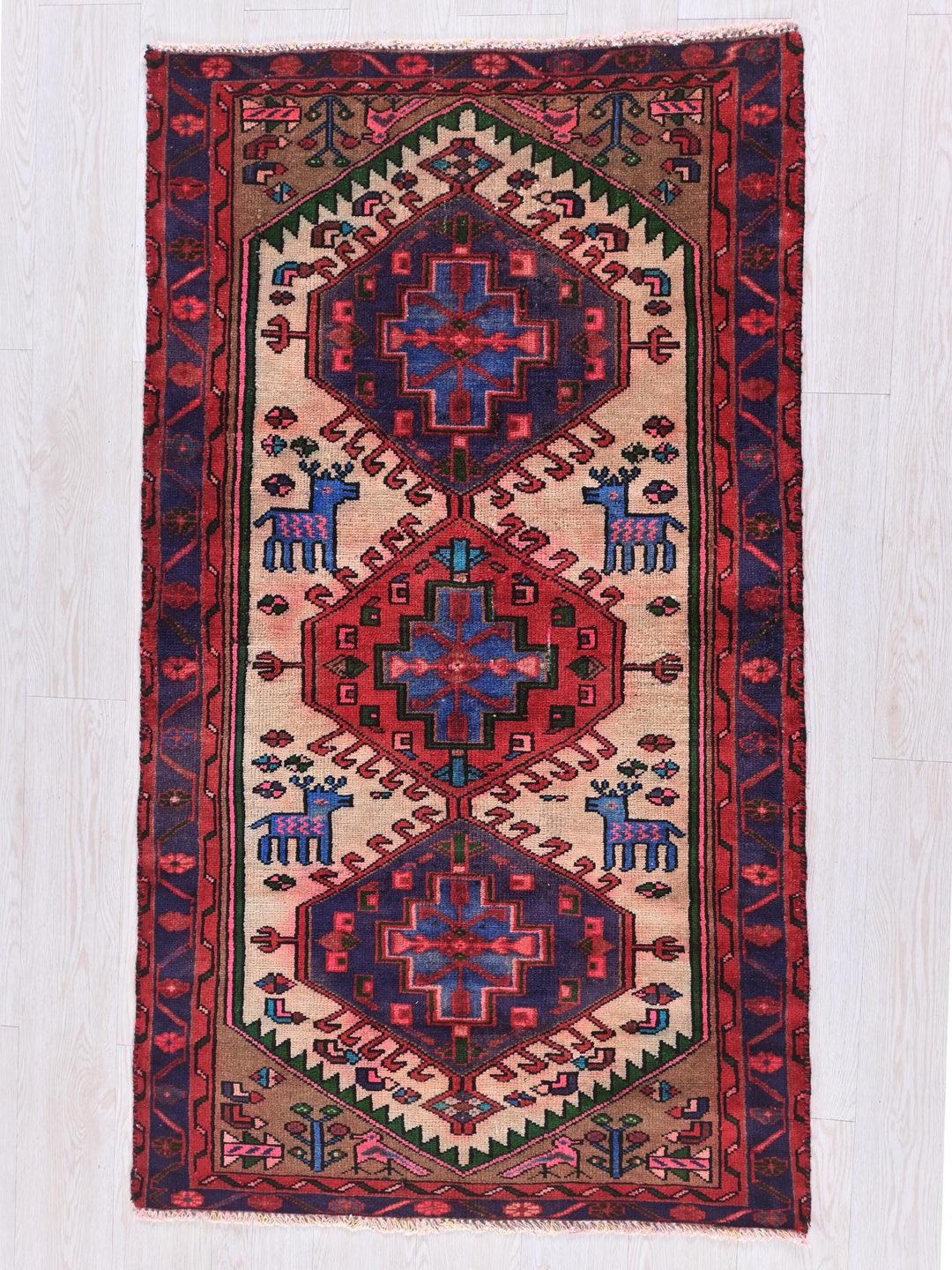 a red and blue rug with animals on it