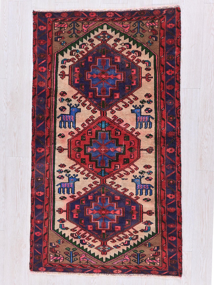 a red and blue rug with animals on it
