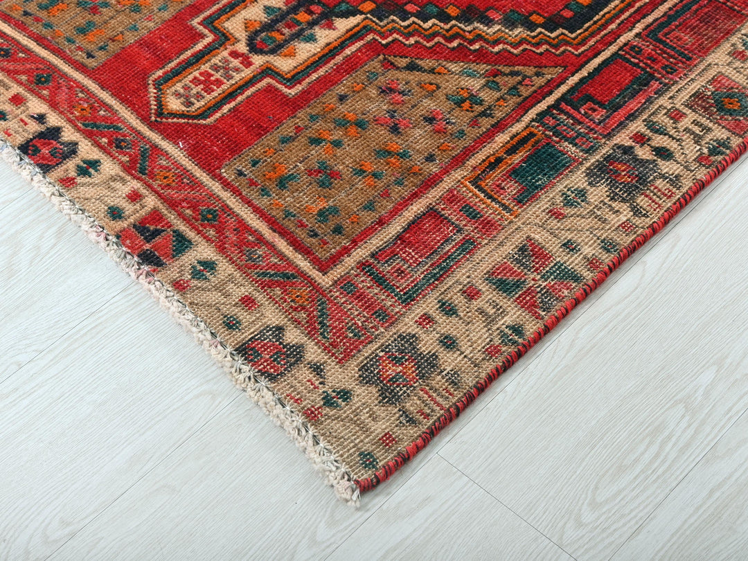 a red and blue rug on a white floor
