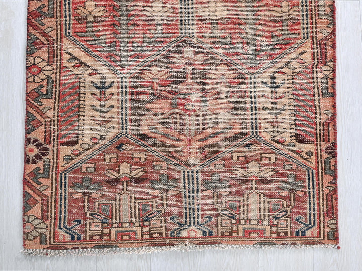 a red rug with a pattern on the middle of it