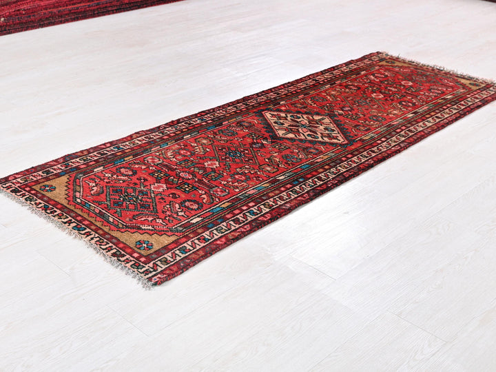 a red rug laying on a white floor