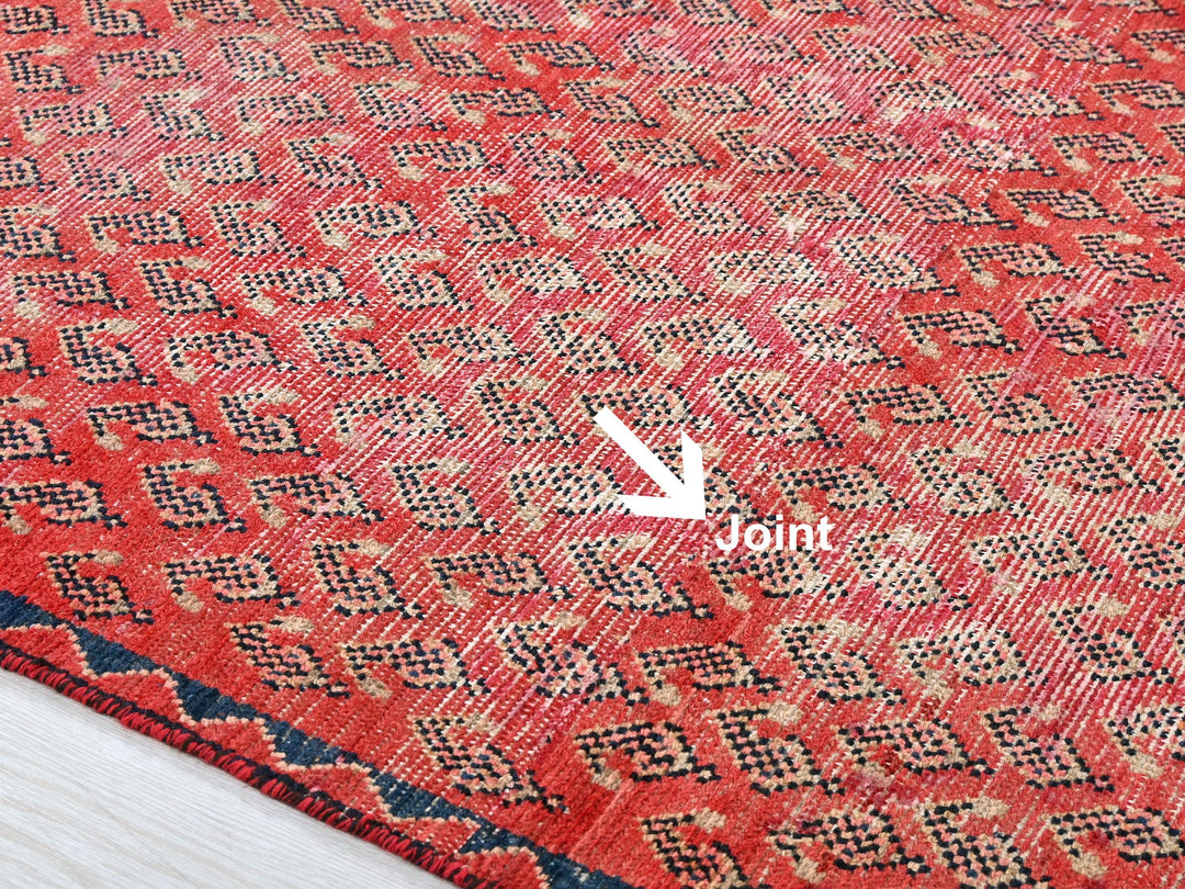 a close up of a red rug with a white arrow pointing to it
