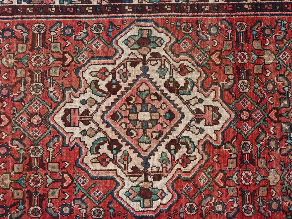 a red rug with a pattern on it